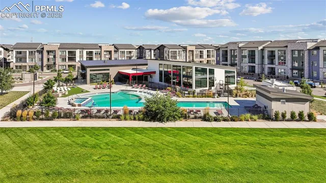 a view of a house with a big yard and sitting area