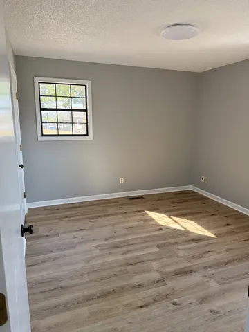 a view of a room with wooden floor and windows