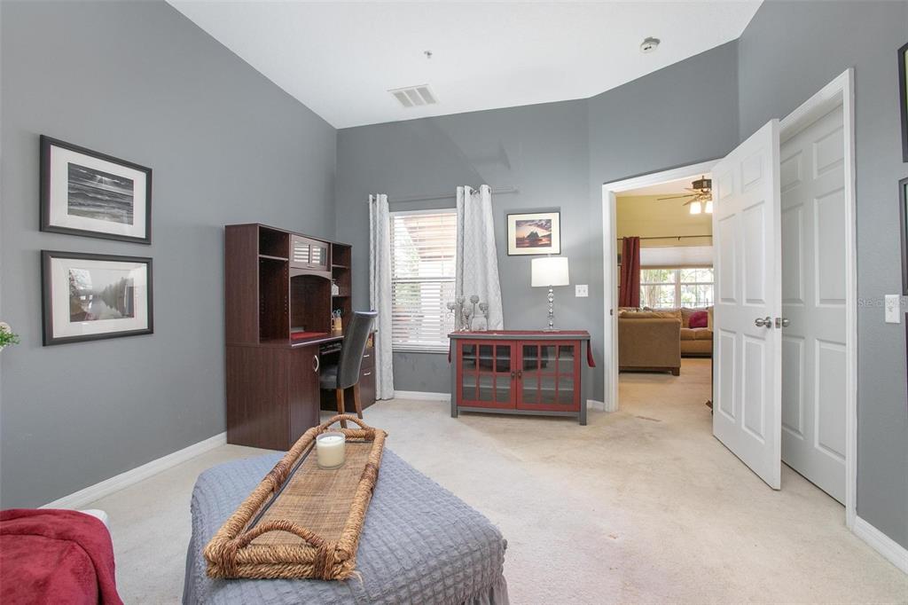 970 North Spring Garden Avenue, Unit 311 Deland, FL 32720 - Photo 12 of 23 a bedroom with furniture and a flat screen tv