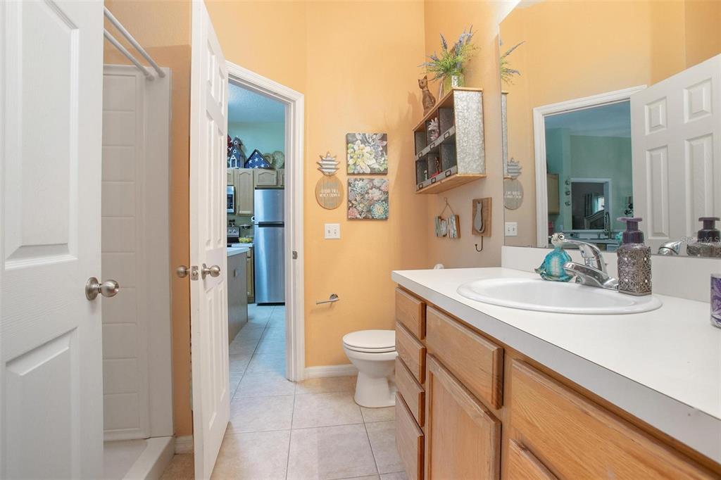 970 North Spring Garden Avenue, Unit 311 Deland, FL 32720 - Photo 14 of 23 a bathroom with a sink a toilet a shower and a mirror
