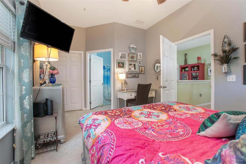 970 North Spring Garden Avenue, Unit 311 Deland, FL 32720 - Photo 17 of 23 a bedroom with a bed and a flat screen tv