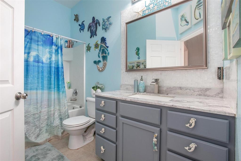 970 North Spring Garden Avenue, Unit 311 Deland, FL 32720 - Photo 18 of 23 a bathroom with a granite countertop sink mirror vanity and toilet