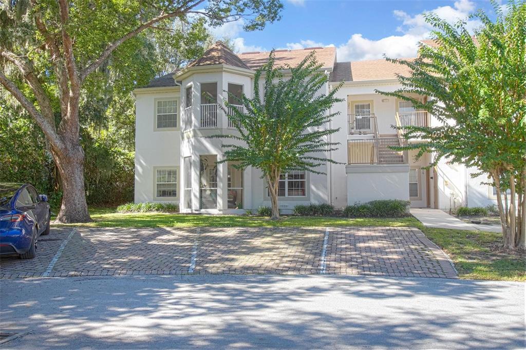 970 North Spring Garden Avenue, Unit 311 Deland, FL 32720 - Photo 22 of 23 a front view of a house with a yard and garage
