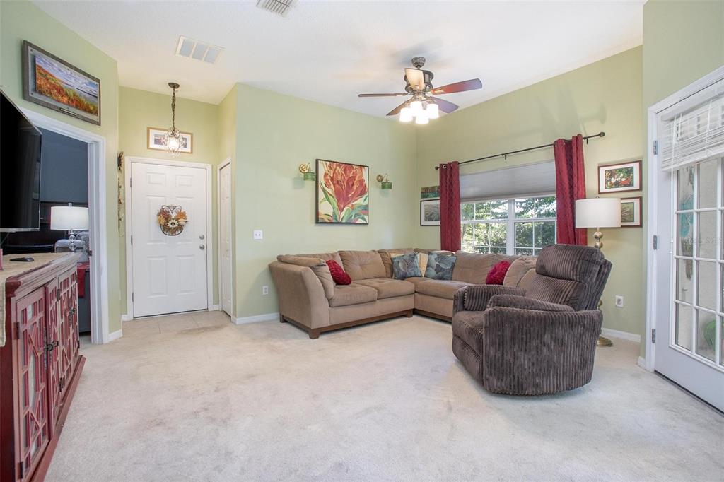970 North Spring Garden Avenue, Unit 311 Deland, FL 32720 - Photo 5 of 23 a living room with furniture and a flat screen tv