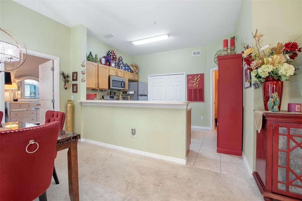 970 North Spring Garden Avenue, Unit 311 Deland, FL 32720 - Photo 7 of 23 a view of a kitchen with fridge and workspace