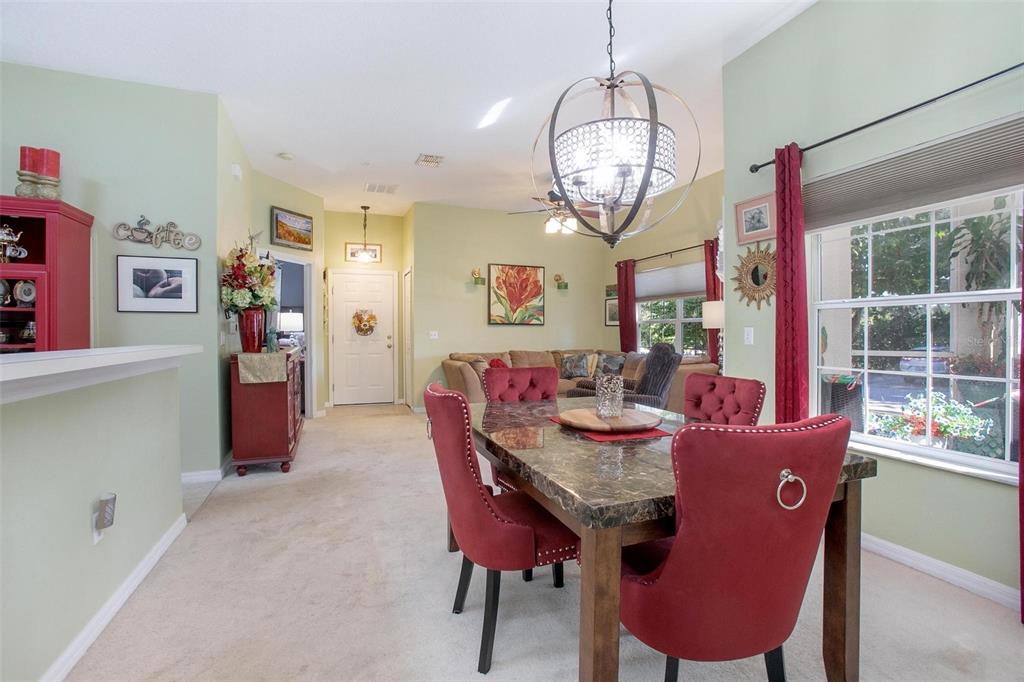 970 North Spring Garden Avenue, Unit 311 Deland, FL 32720 - Photo 8 of 23 a view of a dining room with furniture window and wooden floor
