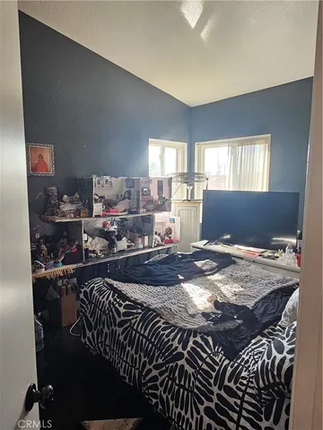 a bed sitting in a room next to a window