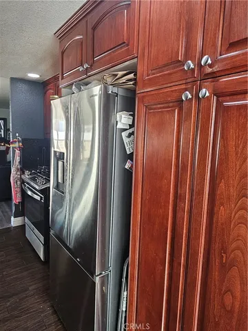 a metallic refrigerator freezer sitting in a kitchen