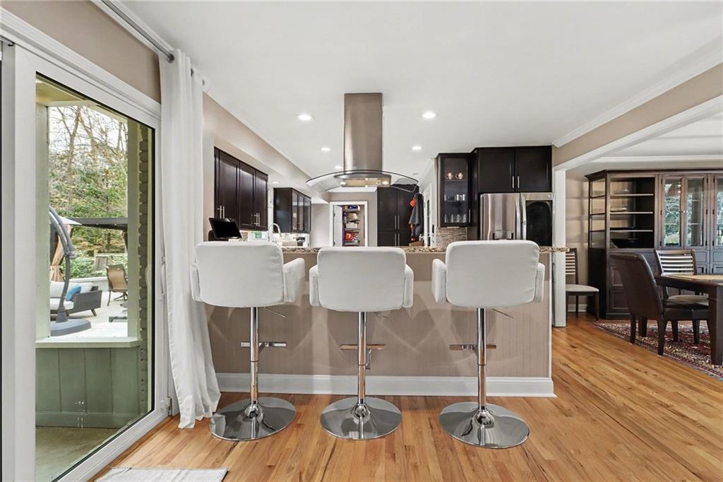 1873 Queens Way Atlanta, GA 30341 - Photo 18 of 56 a kitchen with stainless steel appliances kitchen island granite countertop a dining table chairs and granite counter tops