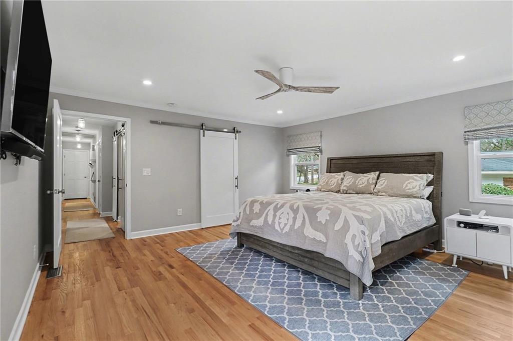 1873 Queens Way Atlanta, GA 30341 - Photo 23 of 56 a spacious bedroom with a bed and a flat screen tv