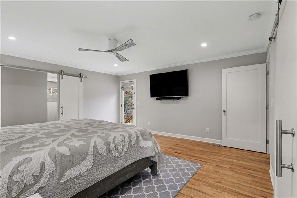 1873 Queens Way Atlanta, GA 30341 - Photo 24 of 56 a bedroom with a bed and a flat screen tv