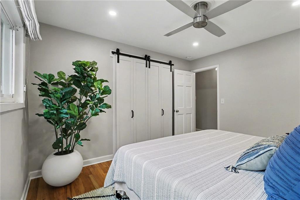 1873 Queens Way Atlanta, GA 30341 - Photo 34 of 56 a bedroom with a large bed and a chandelier