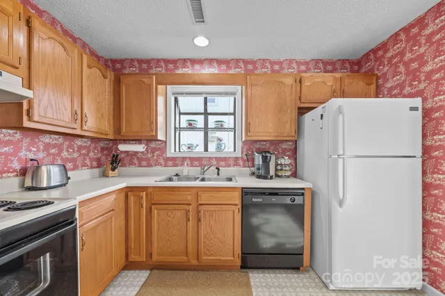a kitchen with a sink stove and refrigerator