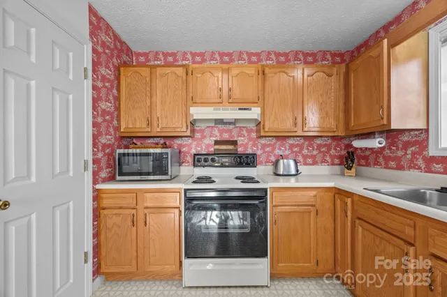 a kitchen with a stove top oven sink and cabinets