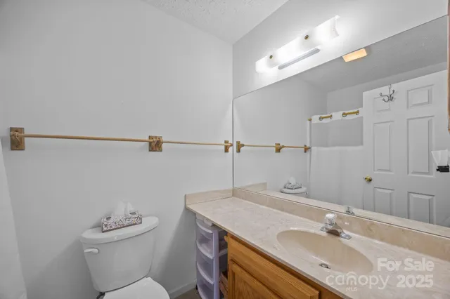 a bathroom with a sink toilet a mirror and shower