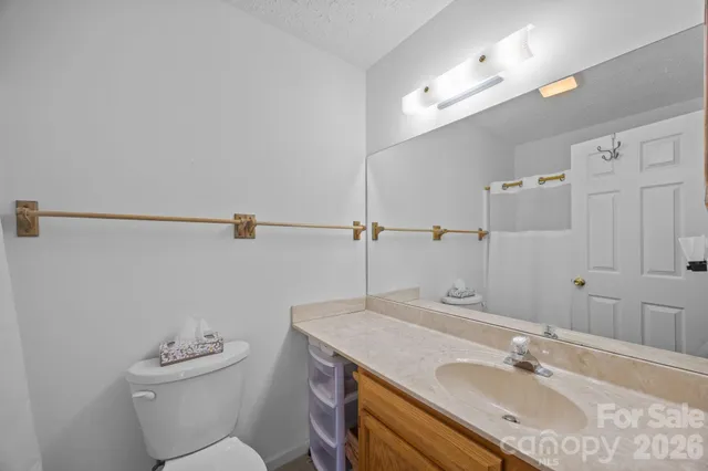 a bathroom with a sink toilet a mirror and shower