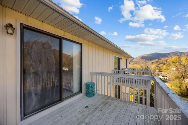 a view of balcony with wooden floor