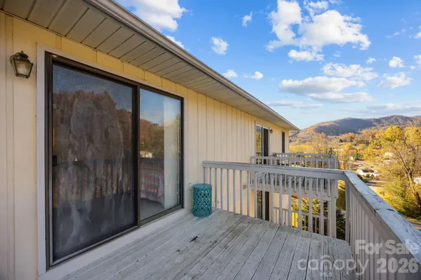 a balcony of a house with wooden floor and outdoor space