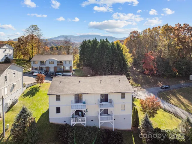 a view of a house with a swimming pool and a yard