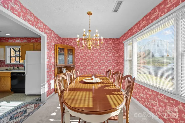 a view of a dining room with furniture and chandelier