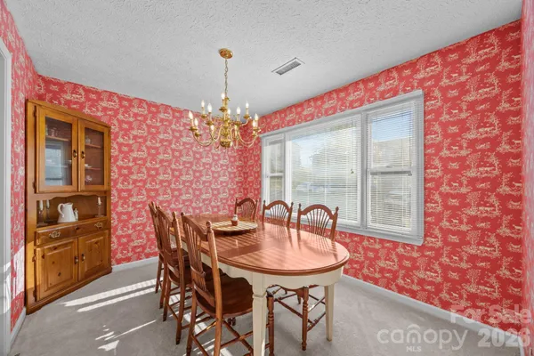 a dining room with furniture and chandelier