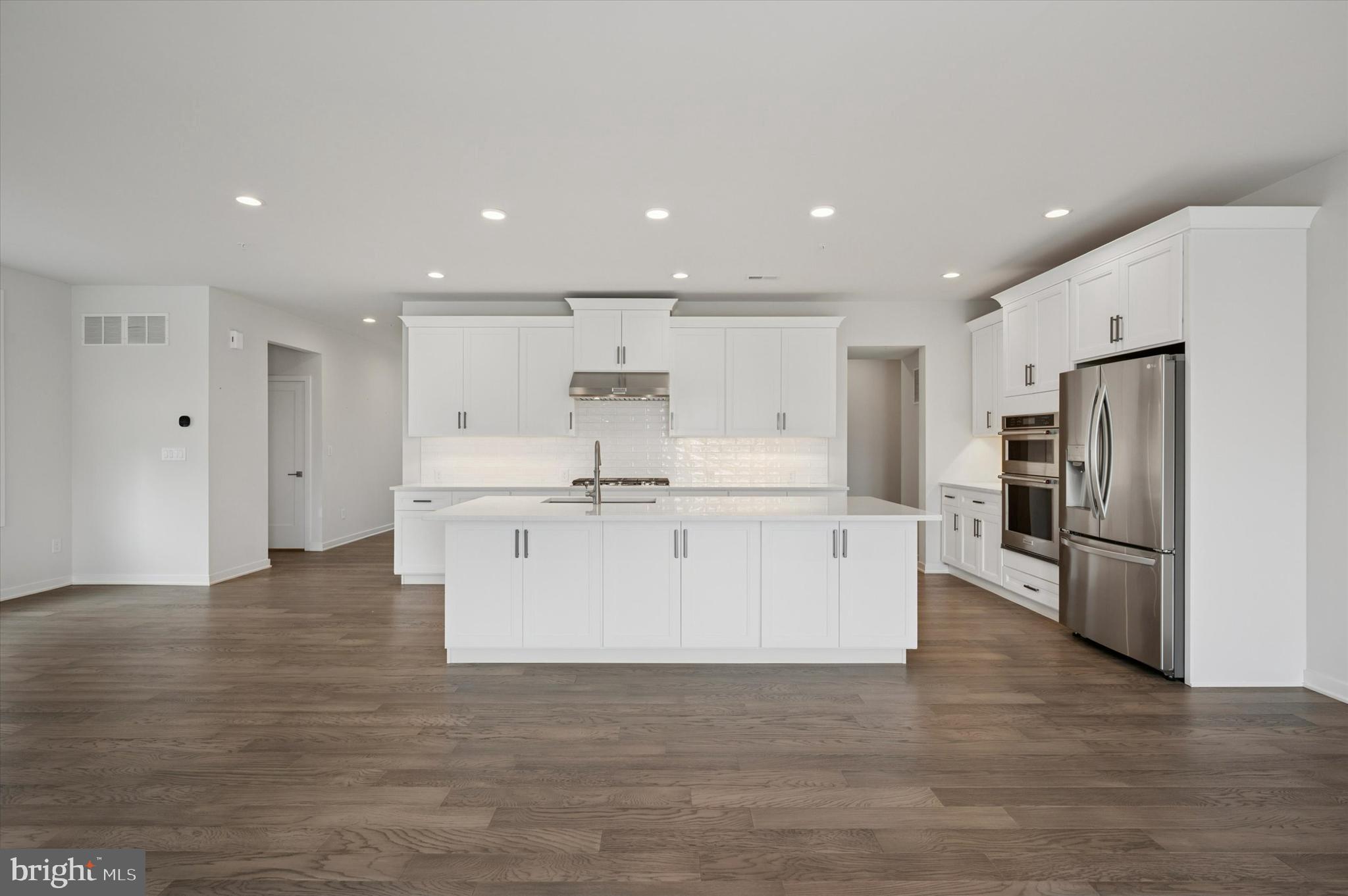 3174 Wier Drive East, Unit E Warrington, PA 18976 - Photo 11 of 37 a large white kitchen with white cabinets and stainless steel appliances