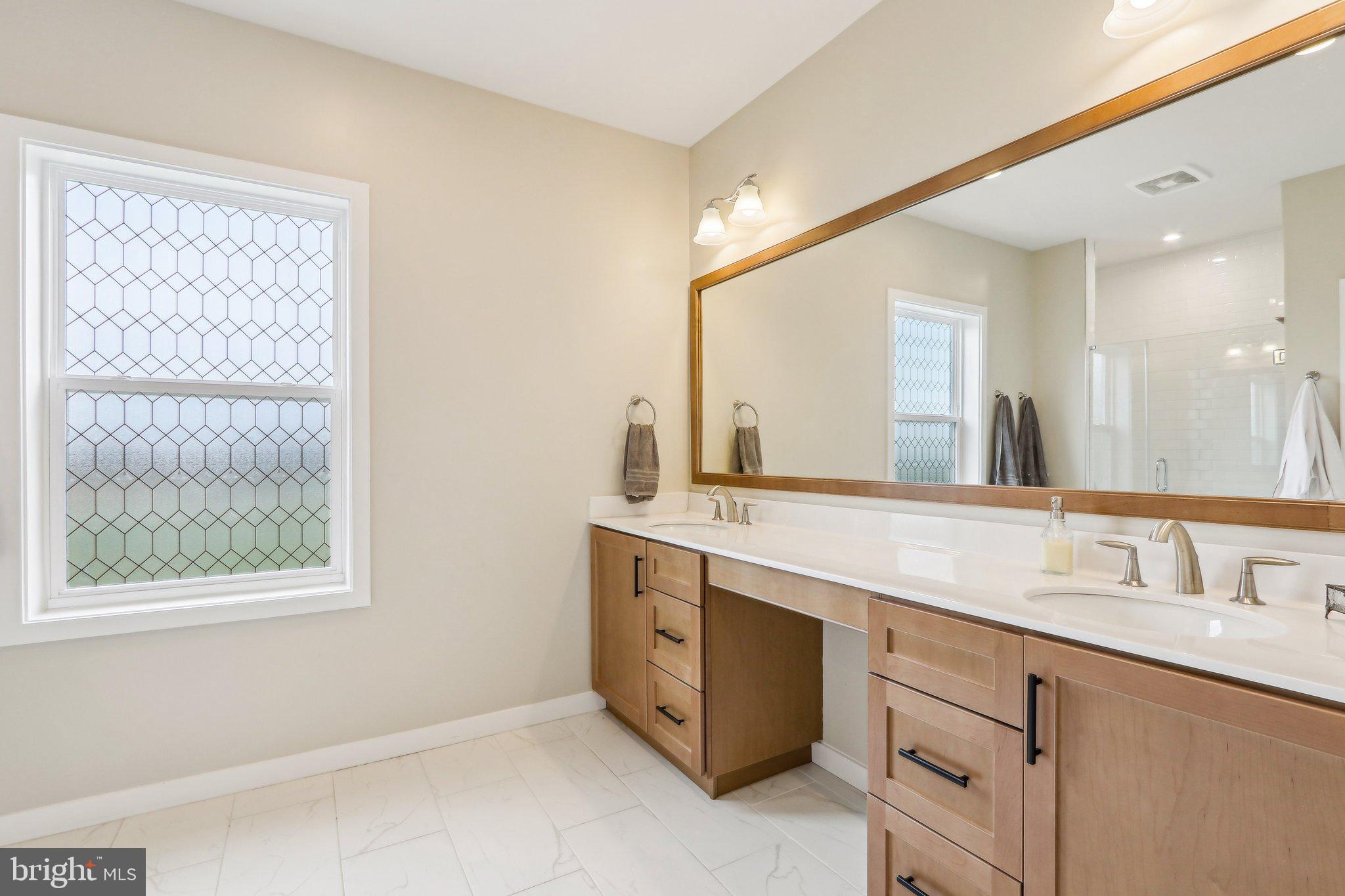 3174 Wier Drive East, Unit E Warrington, PA 18976 - Photo 22 of 37 a bathroom with a double vanity sink and a mirror