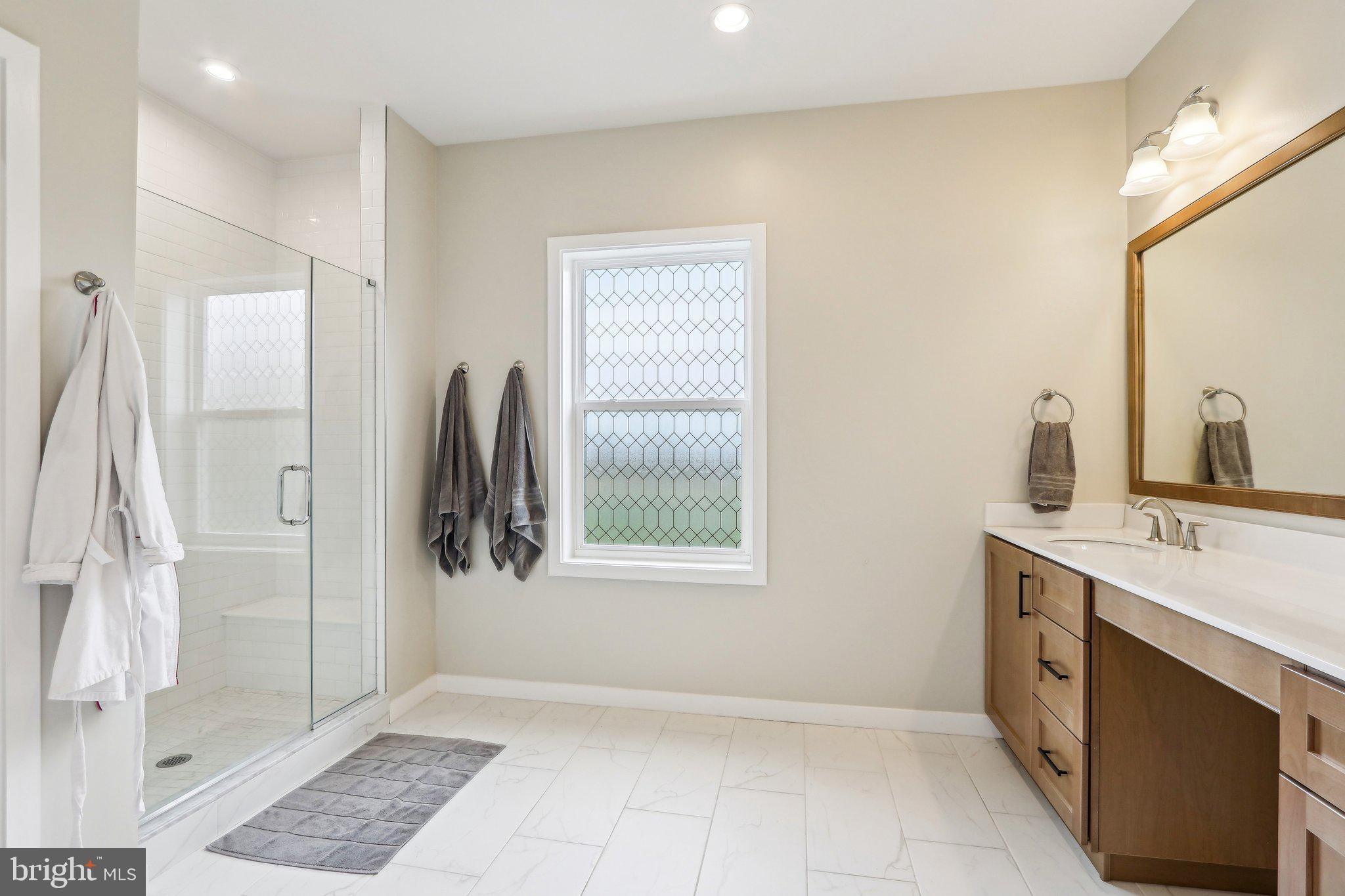 3174 Wier Drive East, Unit E Warrington, PA 18976 - Photo 23 of 37 a bathroom with a sink and a mirror