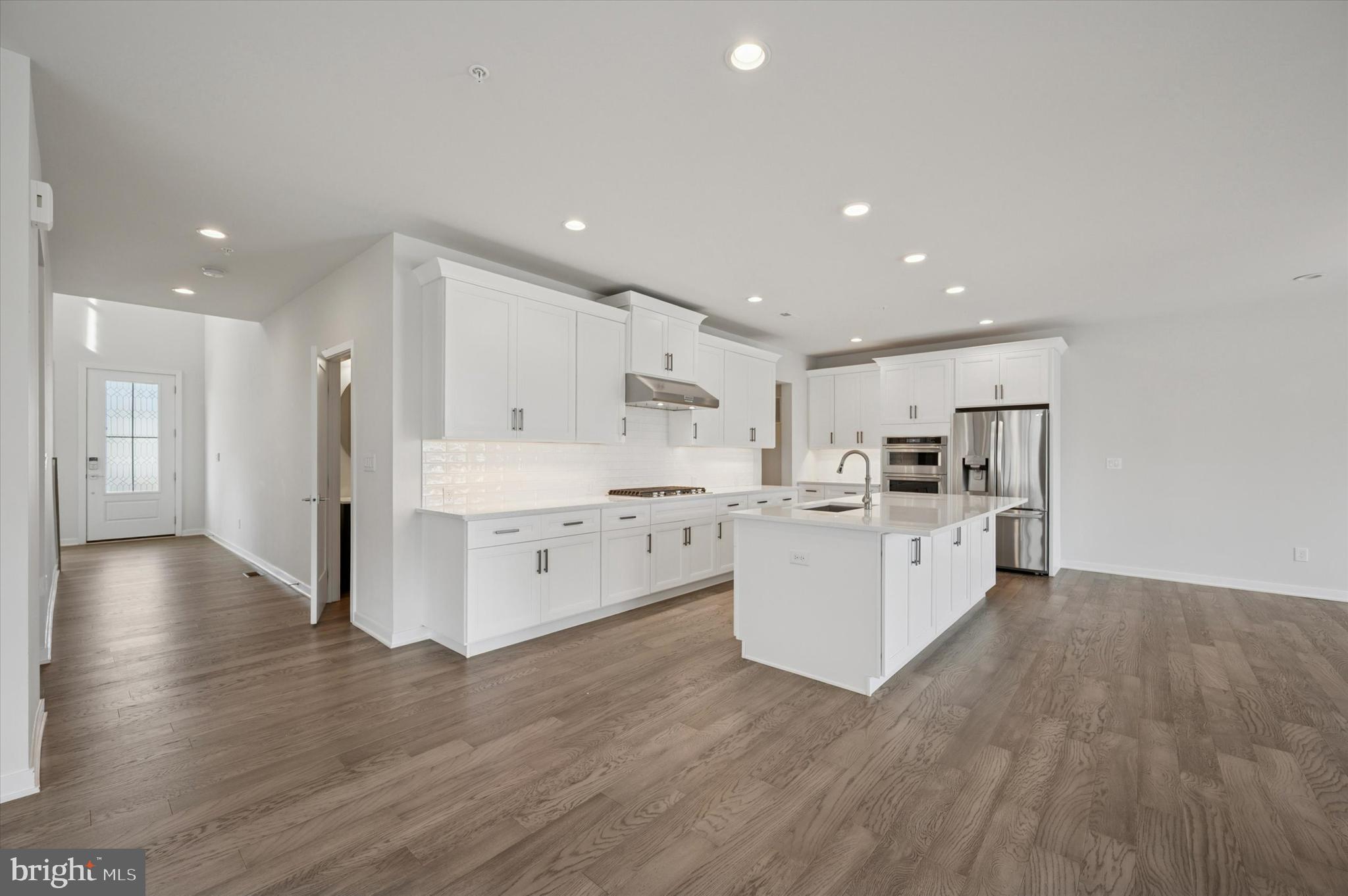3174 Wier Drive East, Unit E Warrington, PA 18976 - Photo 5 of 37 a kitchen with white cabinets and stainless steel appliances