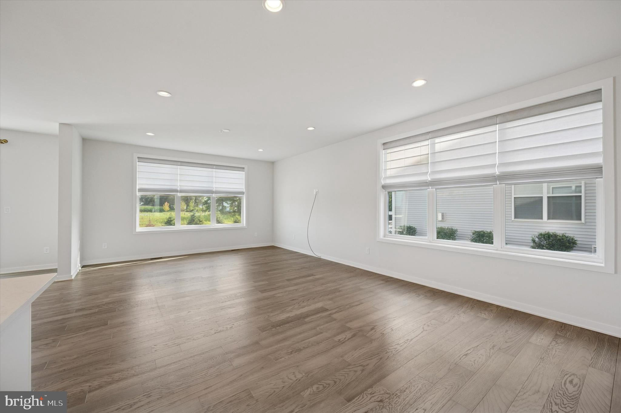 3174 Wier Drive East, Unit E Warrington, PA 18976 - Photo 7 of 37 an empty room with wooden floor and windows