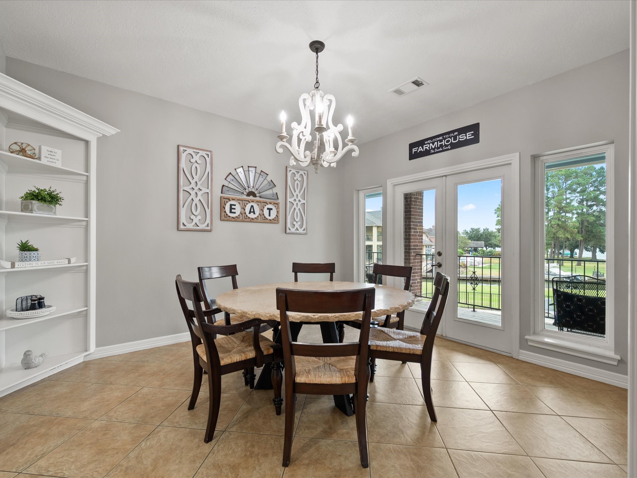 2906 Penninsula Point Montgomery, TX 77356 - Photo 14 of 48 Formal dining room with custom
built-in cabinets and French
doors opening to panoramic lake
views—perfect for sophisticated
entertaining.