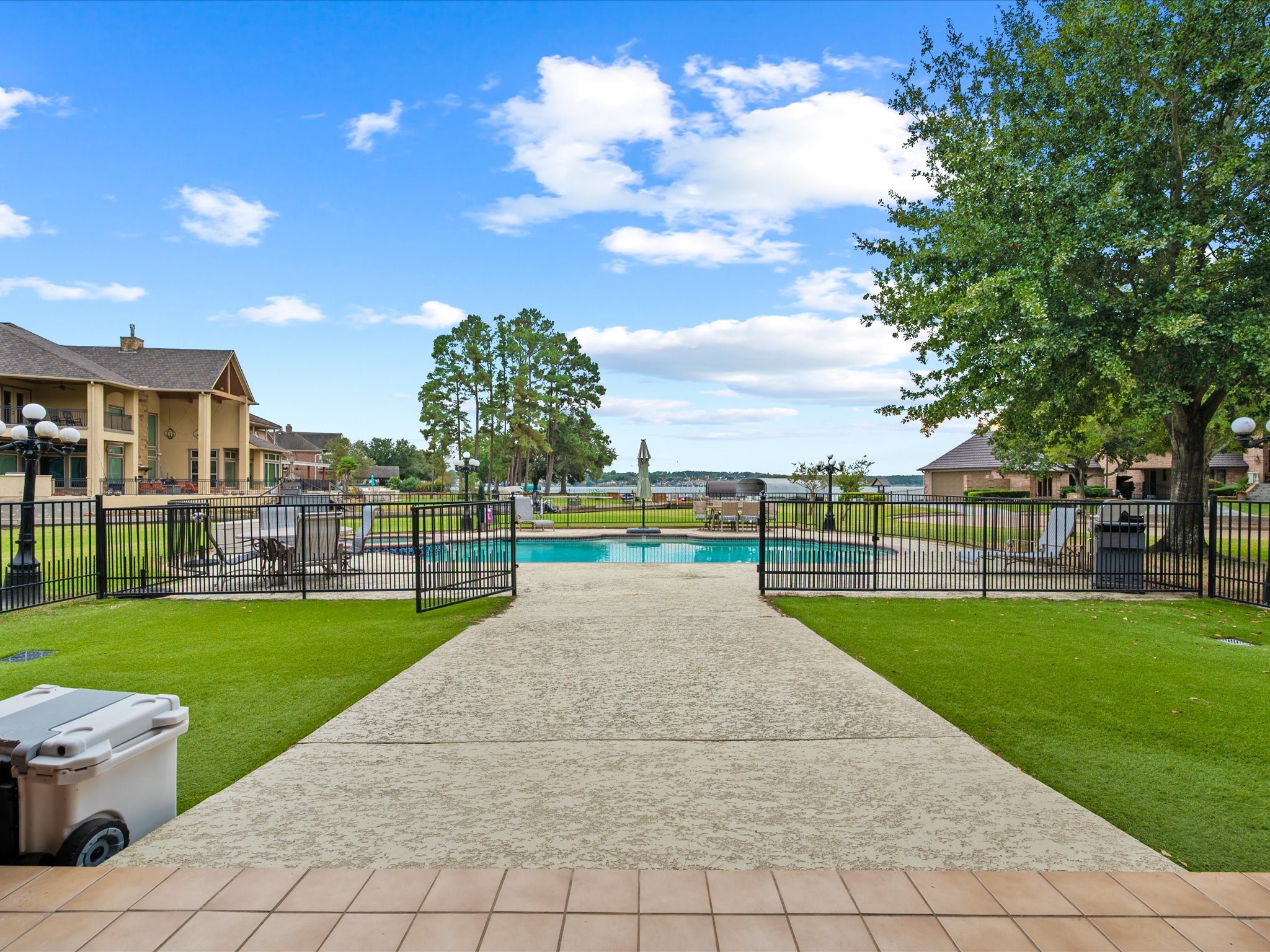 2906 Penninsula Point Montgomery, TX 77356 - Photo 35 of 48 Walkway to the pool with breath
taking views. The surrounding
wrought-iron fence enhances the
space’s elegance while
maintaining safety and charm.