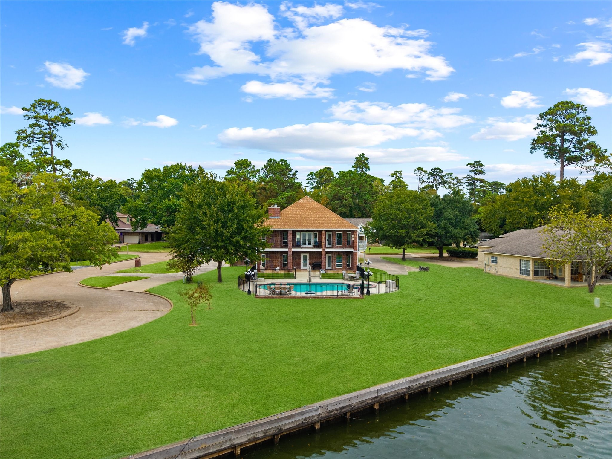 2906 Penninsula Point Montgomery, TX 77356 - Photo 37 of 48 This is the lifestyle you’ve been
dreaming of! Couldn't you
imagine relaxing by your
sparkling pool, soaking in the
lake views, and entertaining in
this stunning back