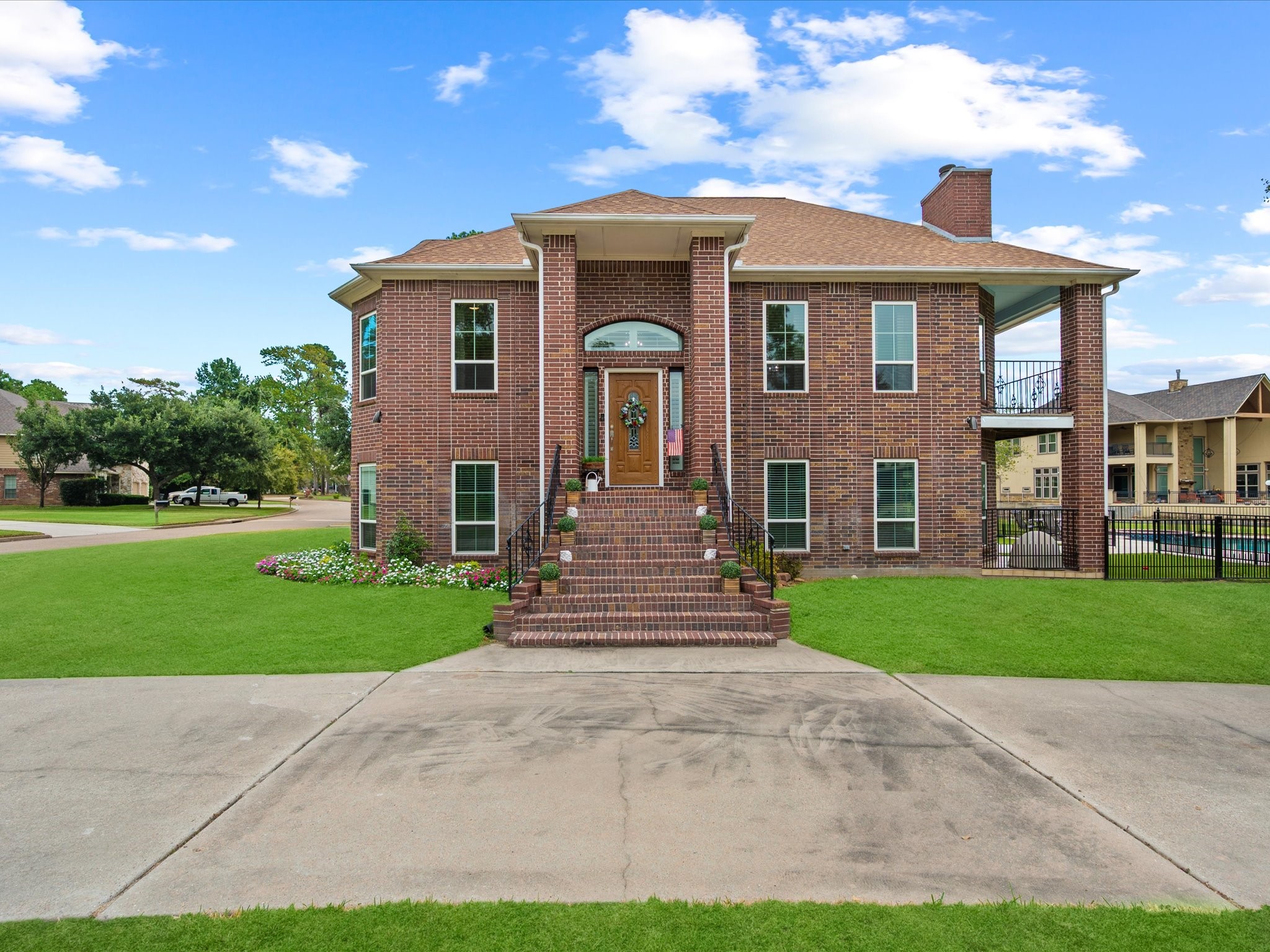 2906 Penninsula Point Montgomery, TX 77356 - Photo 5 of 48 The grand staircase entry makes
an immediate impression,
offering an elegant welcome
enhanced by expansive windows
and thoughtfully designed
landscaping. The combination of
warm brick tones and timeless
architectural detail gives this
home a refined, yet inviting curb
appeal that truly stands out.