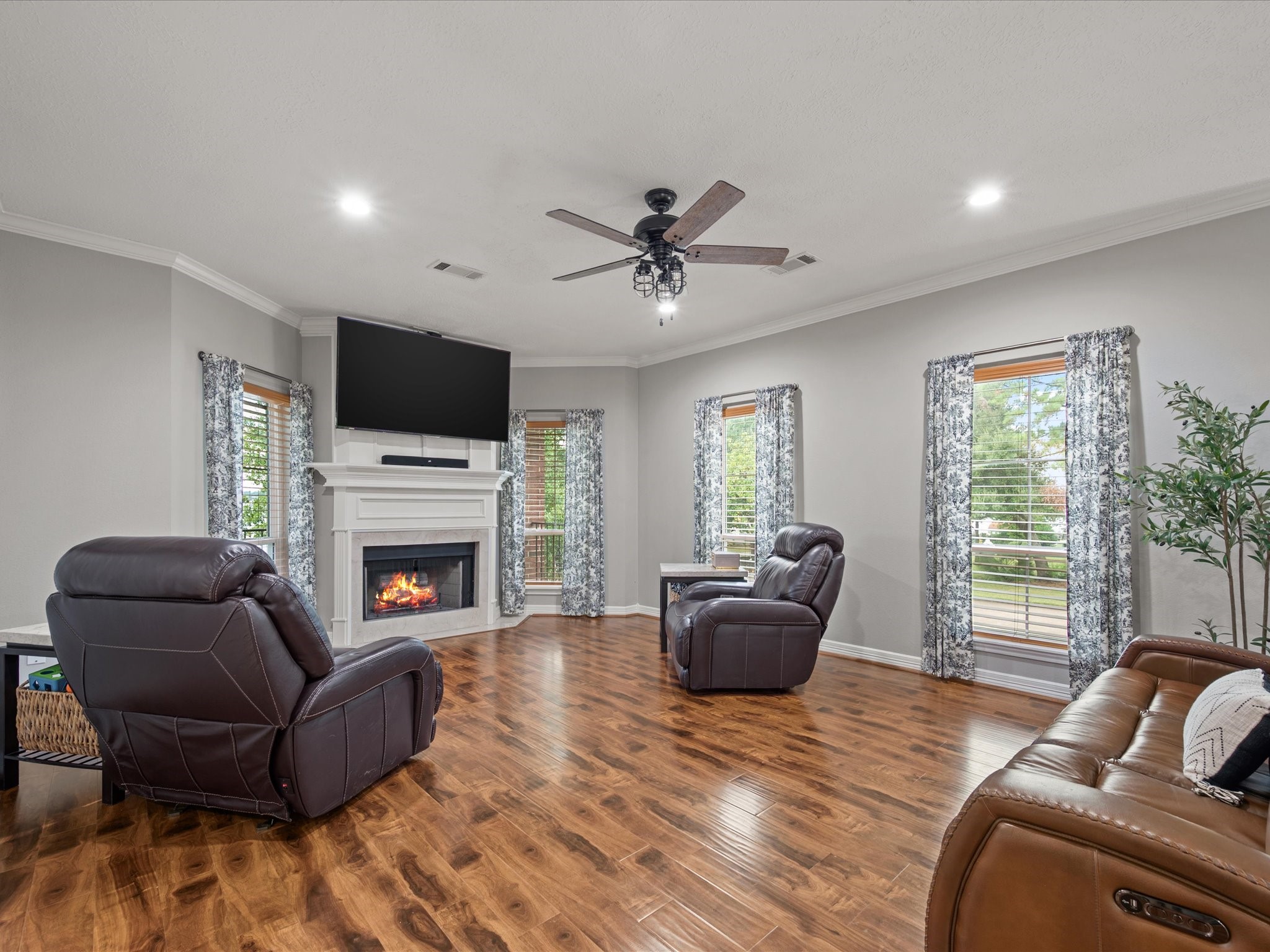 2906 Penninsula Point Montgomery, TX 77356 - Photo 9 of 48 Bathed in natural light, the
elegant living room offers a
perfect balance of comfort and
sophistication, highlighted by a
classic fireplace that anchors the
space and invites relaxation
year-round.