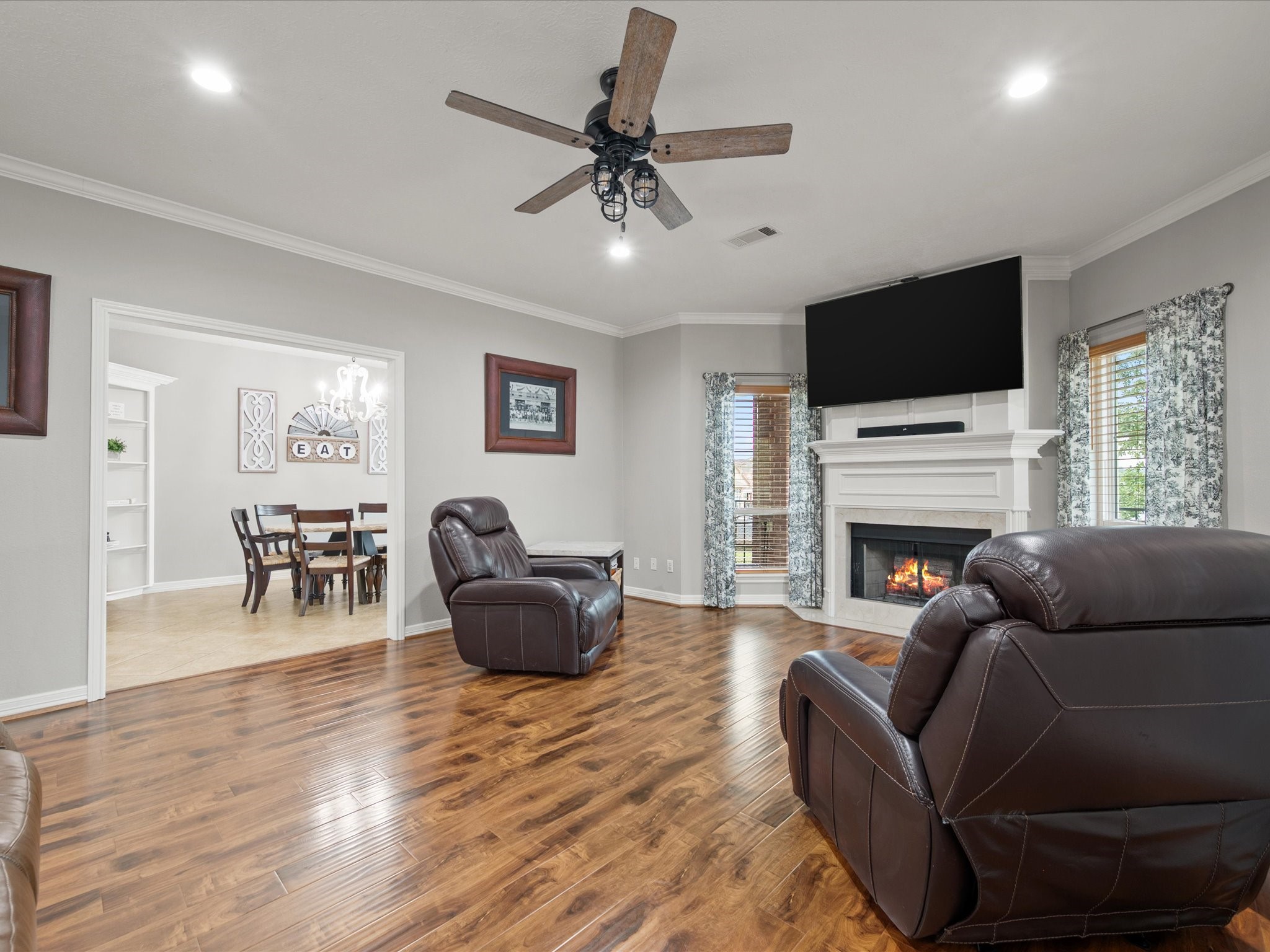 2906 Penninsula Point Montgomery, TX 77356 - Photo 10 of 48 Bathed in natural light, the
elegant living room offers a
perfect balance of comfort and
sophistication, highlighted by a
classic fireplace that anchors the
space and invites relaxation
year-round.
