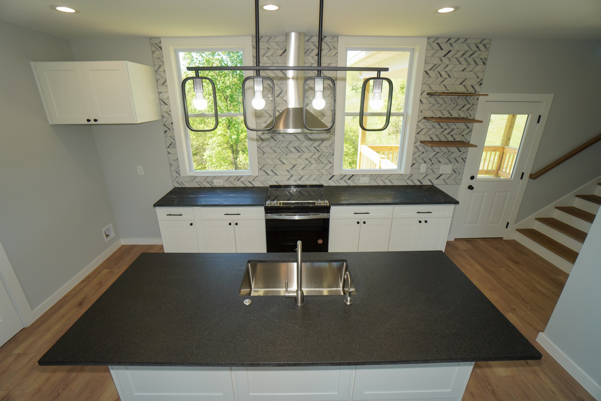 3035 Wixtown Road Westmoreland, TN 37186 - Photo 7 of 8 a view of kitchen island with stainless steel appliances granite countertop a stove a sink and a dining table