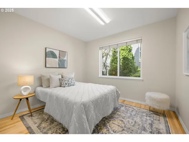 a bedroom with a bed window and a lamp