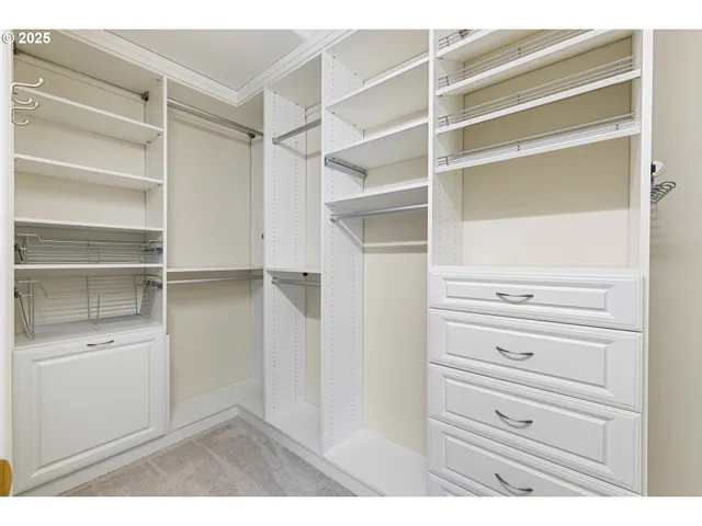 a view of walk in closet with empty racks