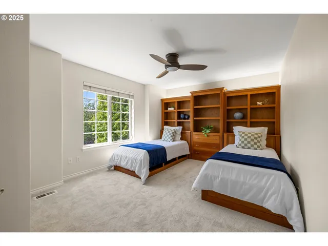 a spacious bedroom with a bed and a large window