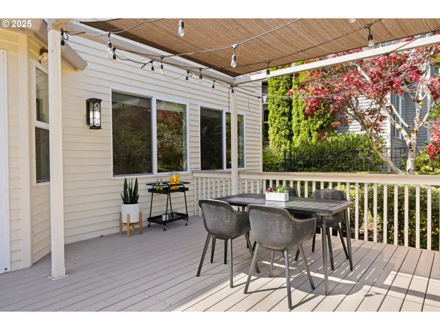 a view of a chairs and table on the wooden deck