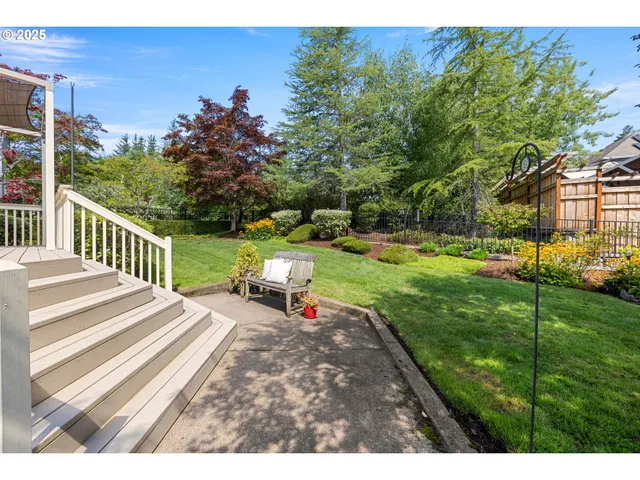 a view of a chair and table on the garden