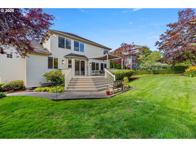 a front view of a house with a yard table and chairs