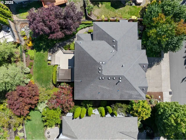 a view of a house with a yard and potted plants