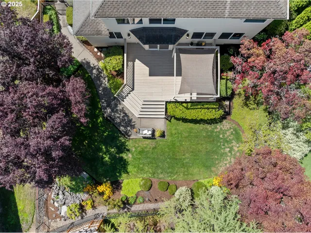 an aerial view of a house with a garden and lots of residential buildings