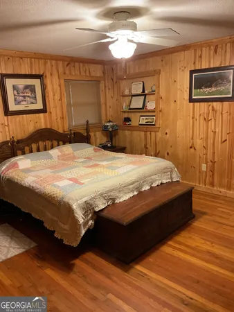a bed sitting in a bedroom and a night stand