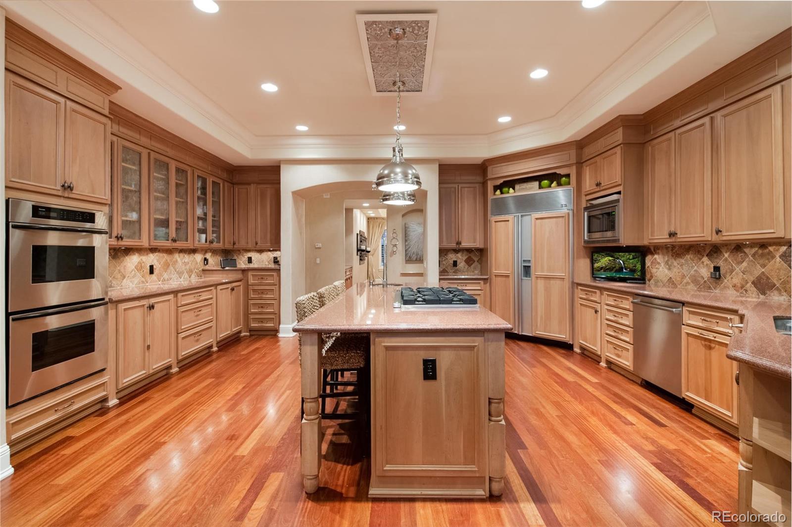 3 Sandy Lake Road Englewood, CO 80113 - Photo 15 of 35 a kitchen with kitchen island stainless steel appliances a stove refrigerator sink and cabinets