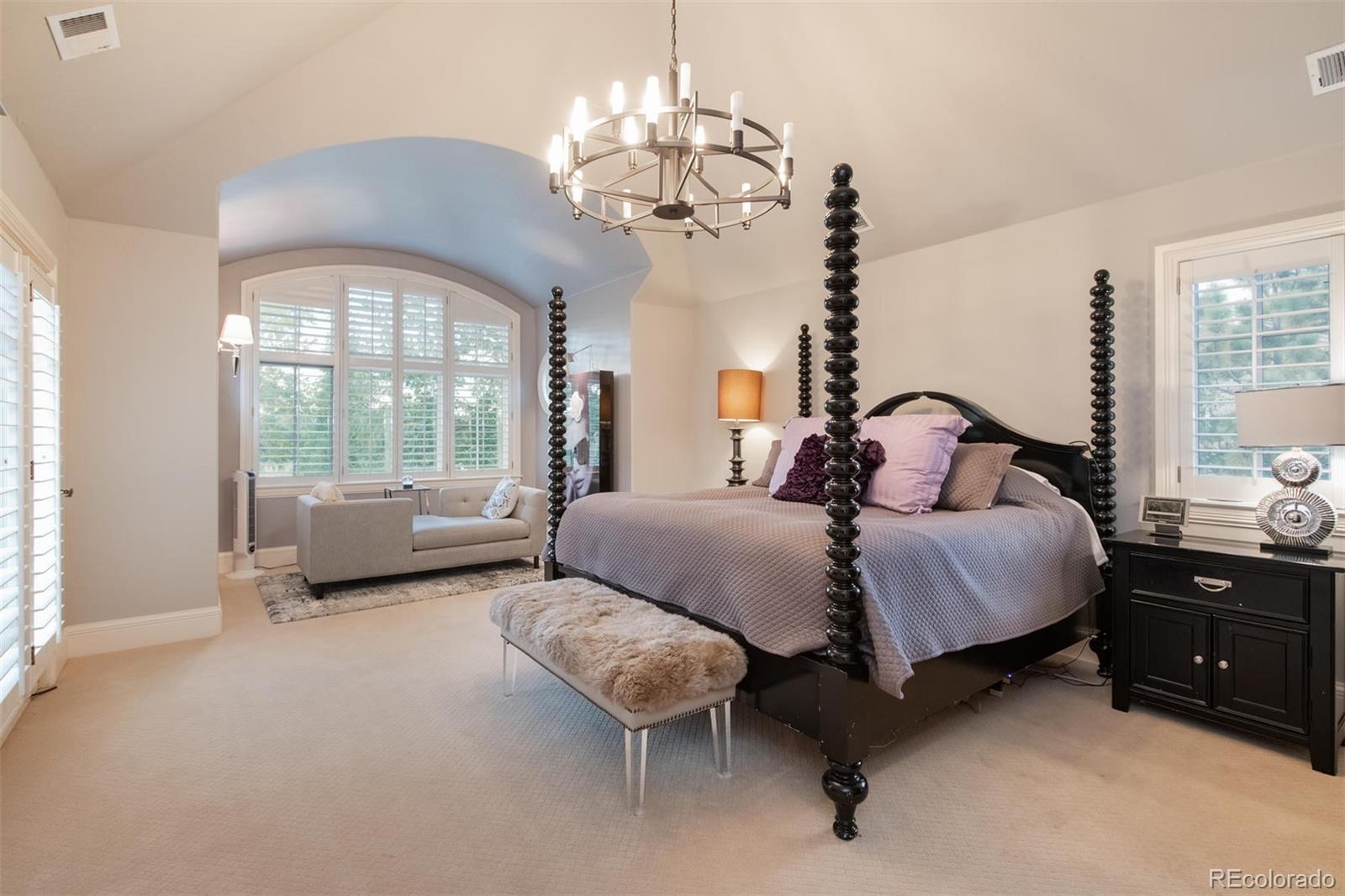 3 Sandy Lake Road Englewood, CO 80113 - Photo 18 of 35 a bedroom with a large bed and a chandelier fan