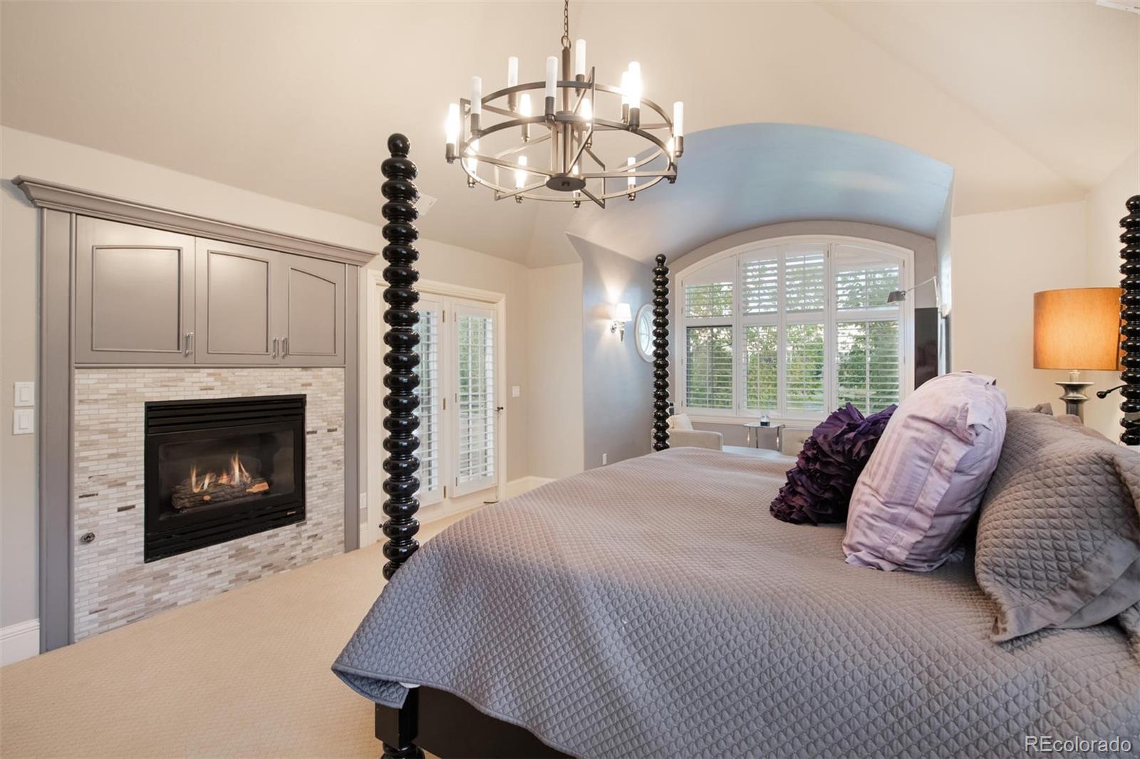 3 Sandy Lake Road Englewood, CO 80113 - Photo 19 of 35 a large bedroom with a bed and a fireplace