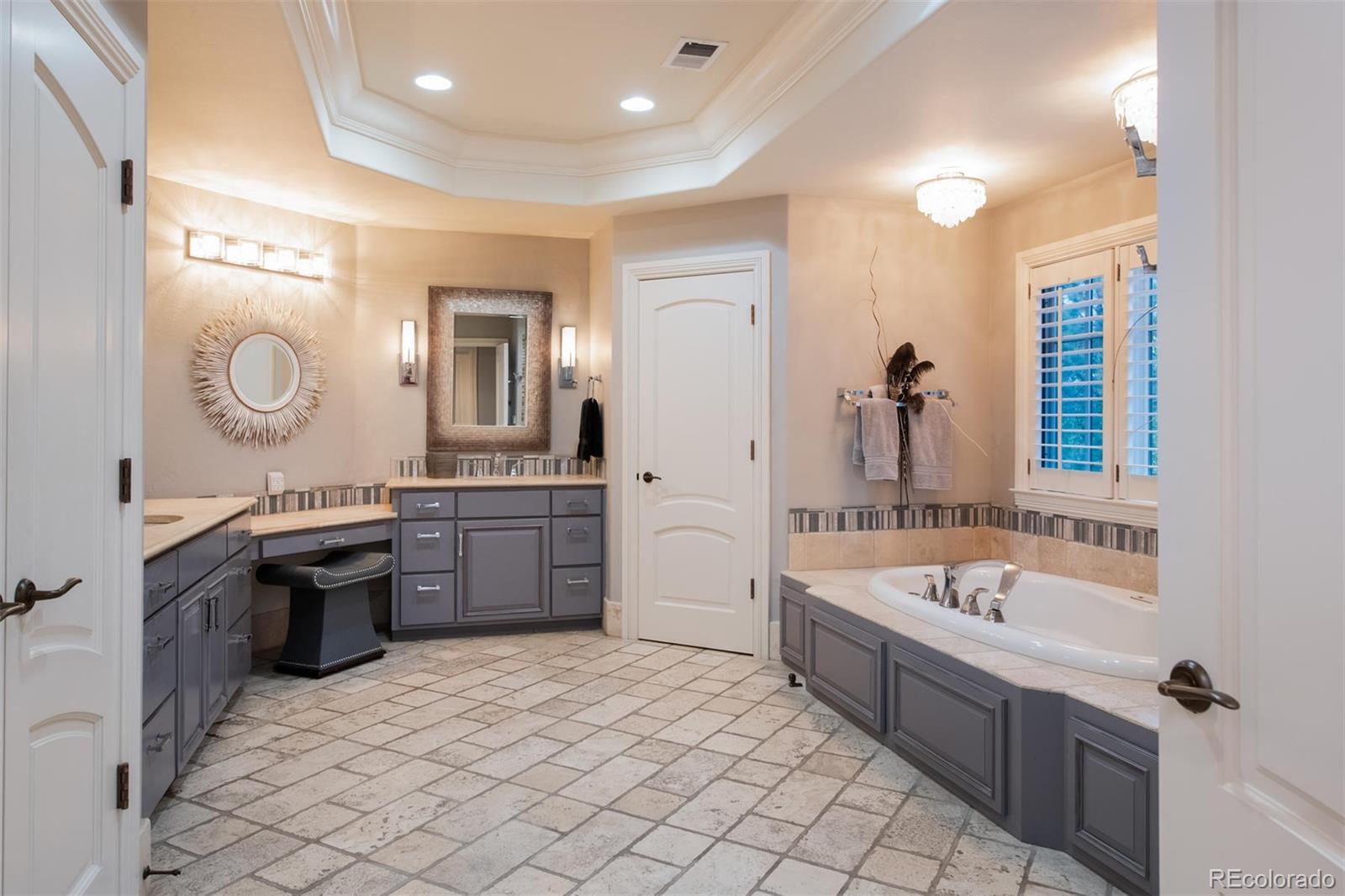 3 Sandy Lake Road Englewood, CO 80113 - Photo 20 of 35 a large bathroom with a tub sink and mirror